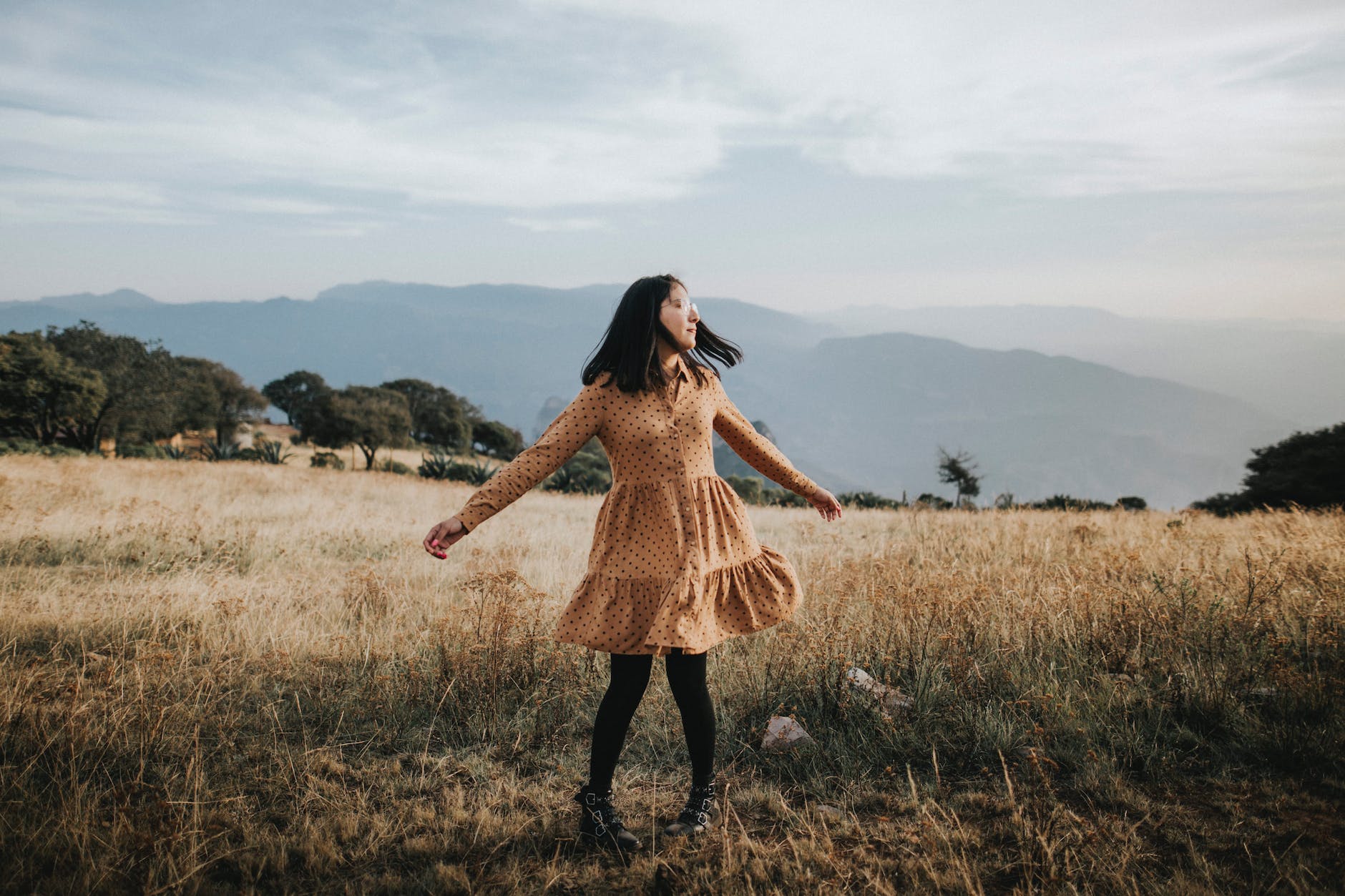 woman wearing brown long sleeved dress